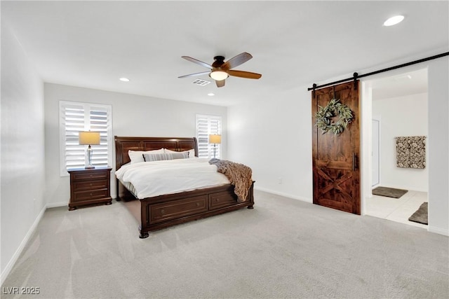 bedroom featuring light colored carpet, multiple windows, recessed lighting, and a barn door