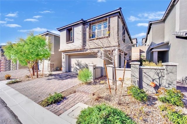 view of front of house with a garage, decorative driveway, and stucco siding