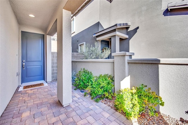 property entrance featuring stucco siding