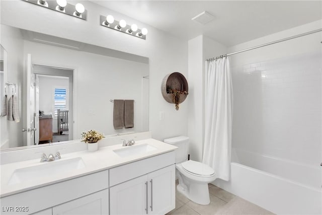 full bath with double vanity, shower / bath combo with shower curtain, a sink, and tile patterned floors