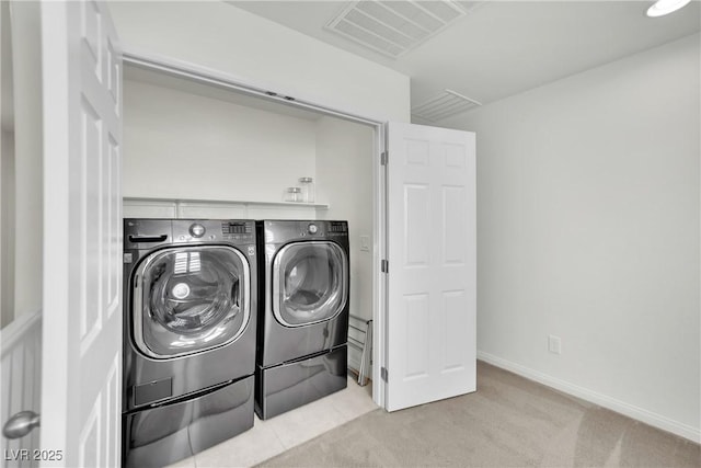 washroom featuring washing machine and dryer, light colored carpet, laundry area, visible vents, and baseboards