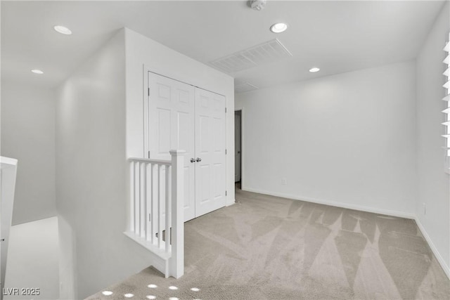 hall featuring recessed lighting, visible vents, baseboards, and light colored carpet