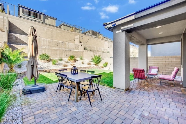 view of patio featuring outdoor dining space and a fenced backyard