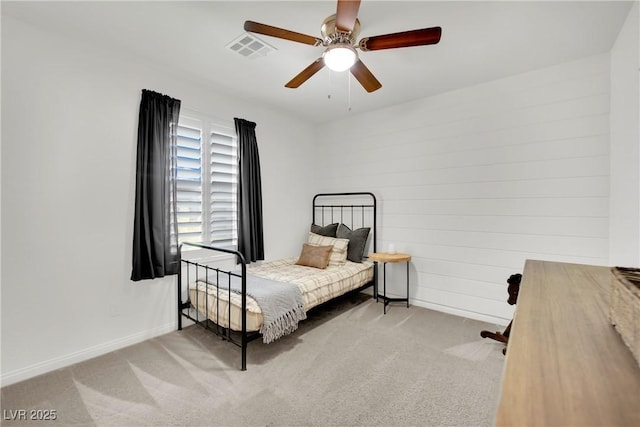 bedroom featuring light carpet, baseboards, visible vents, and a ceiling fan