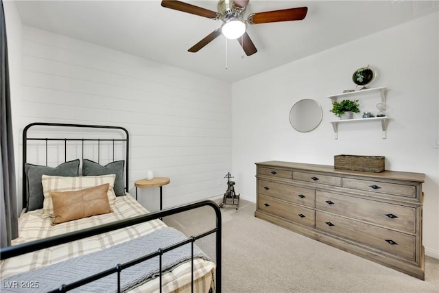 bedroom with light carpet and a ceiling fan