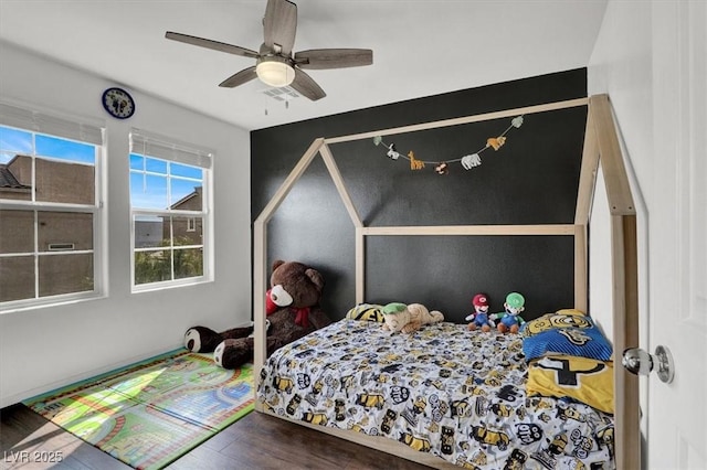 bedroom with wood finished floors and a ceiling fan