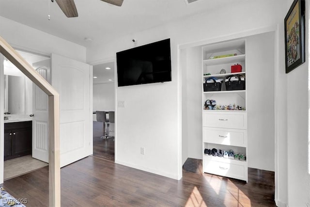 bedroom with dark wood-style floors, a sink, and baseboards