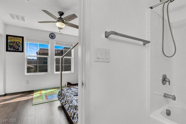 bedroom featuring ceiling fan, wood finished floors, and visible vents