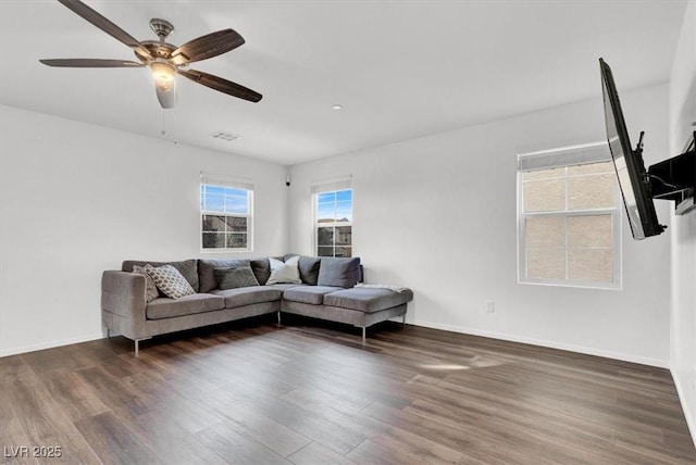 living area with baseboards, visible vents, and dark wood-type flooring