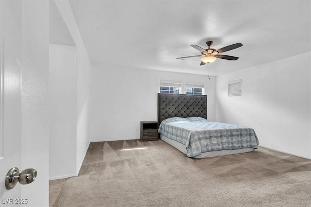 bedroom featuring light carpet and a ceiling fan