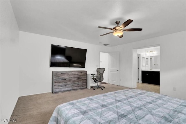 bedroom with light carpet, visible vents, a ceiling fan, and ensuite bathroom