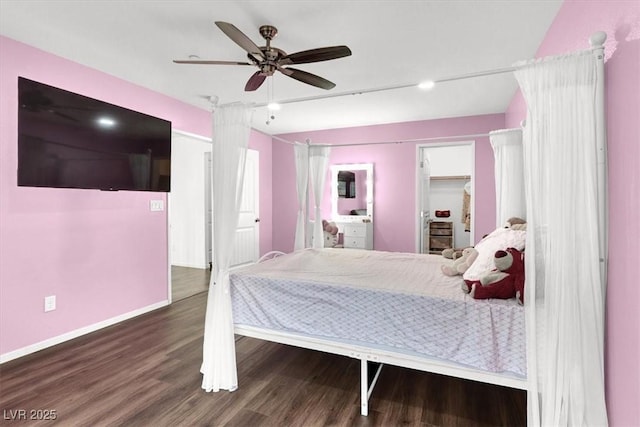 bedroom with a ceiling fan, baseboards, and dark wood-type flooring