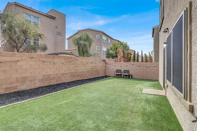 view of yard with a fenced backyard