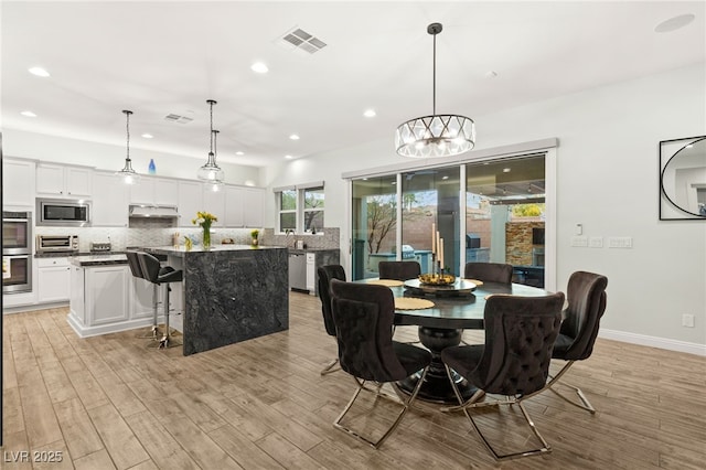 dining space with visible vents, recessed lighting, and light wood-style floors