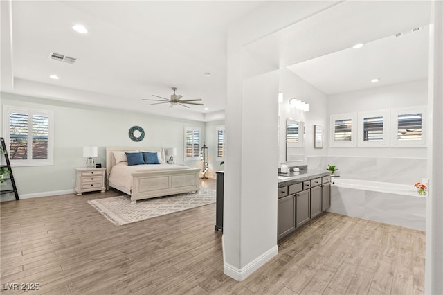 bedroom featuring light wood-type flooring, visible vents, and recessed lighting