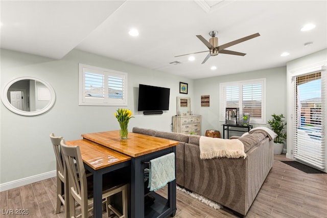 living room featuring recessed lighting, light wood-style flooring, and baseboards