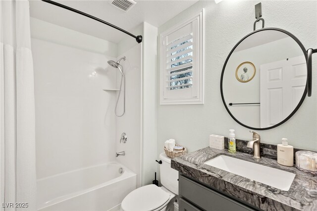 bathroom featuring visible vents, toilet, vanity, and bathtub / shower combination