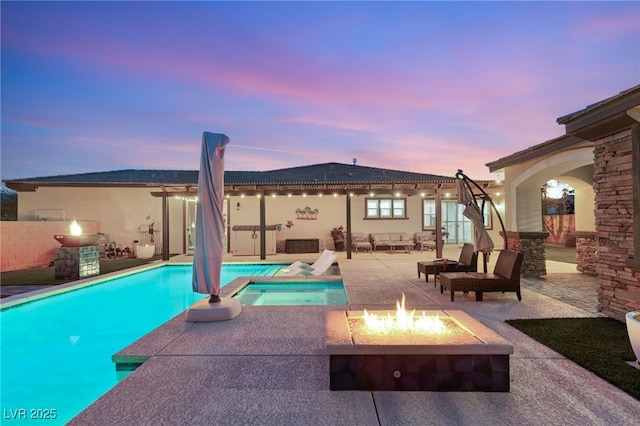 view of swimming pool with a fenced in pool, a patio, and an outdoor fire pit