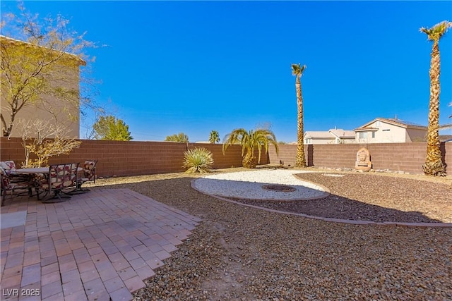 view of yard featuring a patio area and a fenced backyard