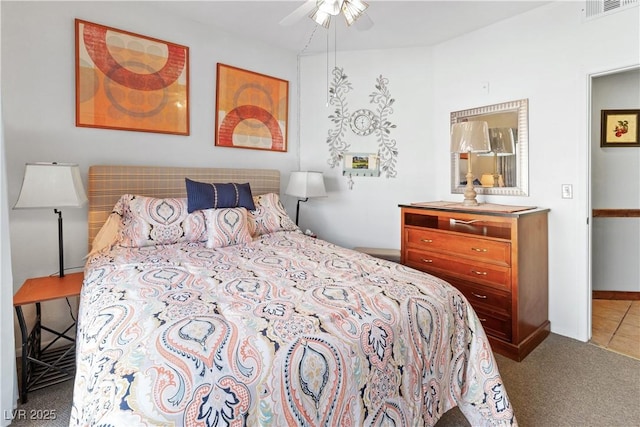 carpeted bedroom featuring ceiling fan and visible vents