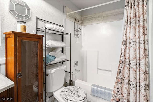 bathroom featuring toilet, shower / bath combo with shower curtain, and a textured wall