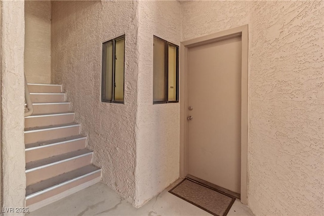 view of exterior entry with stucco siding