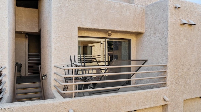 doorway to property featuring stucco siding