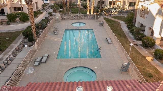 view of pool with a patio area and a hot tub