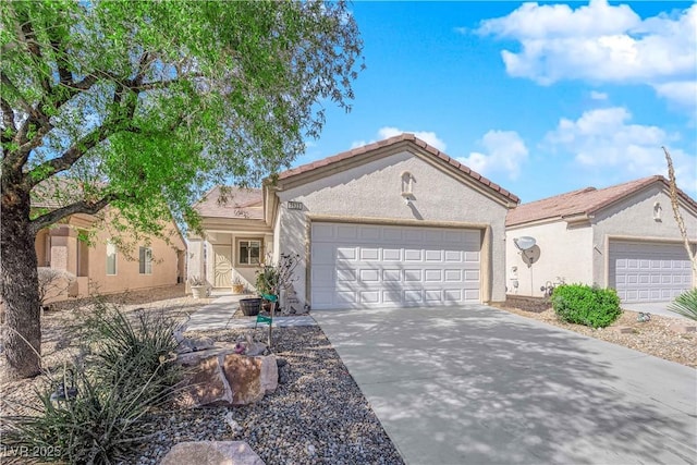 view of front facade with stucco siding, concrete driveway, and an attached garage