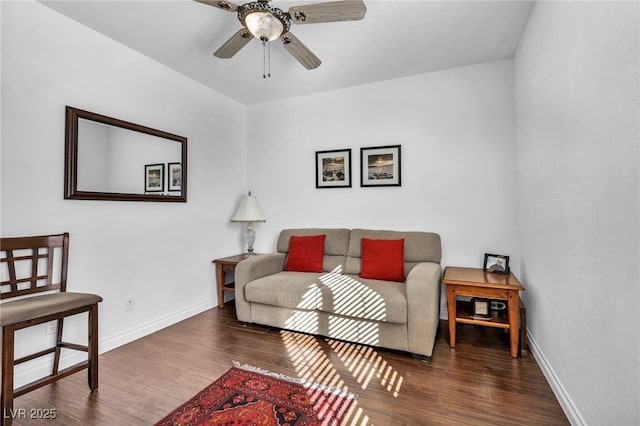 living area with wood finished floors, a ceiling fan, and baseboards