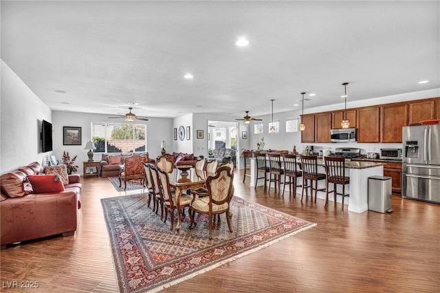 dining space with ceiling fan, a toaster, wood finished floors, and recessed lighting