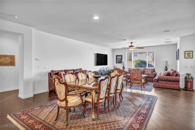 dining space featuring a textured ceiling, wood finished floors, visible vents, and baseboards