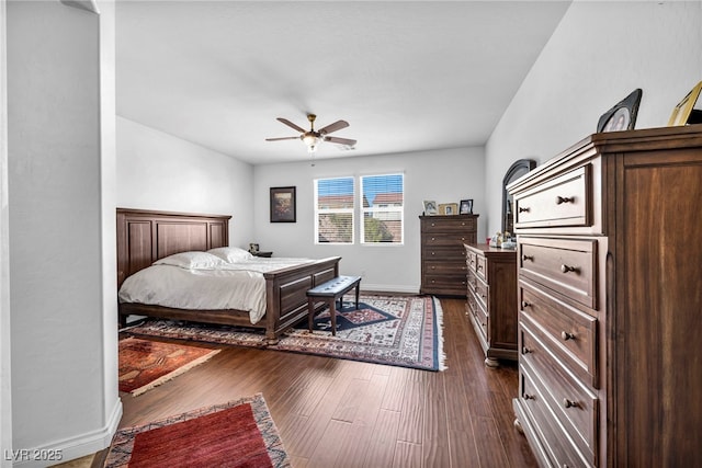 bedroom featuring ceiling fan, dark wood-style flooring, and baseboards