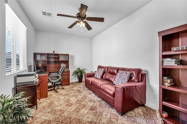 office area with ceiling fan, visible vents, and baseboards