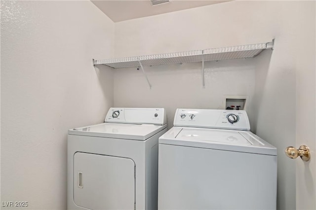 clothes washing area with laundry area and separate washer and dryer