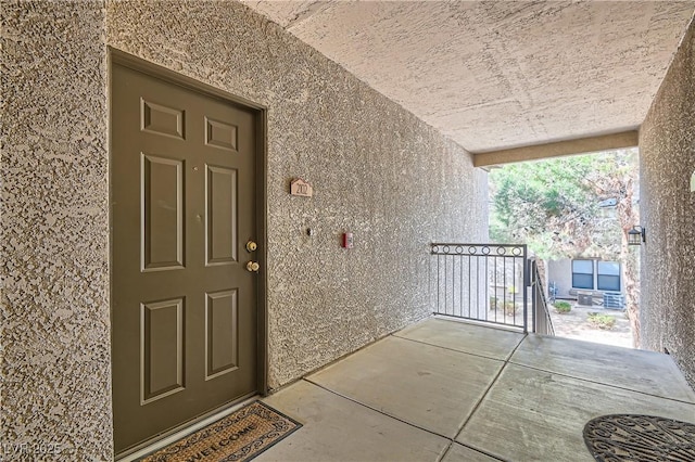 view of exterior entry featuring stucco siding