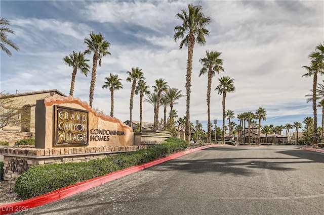 view of street with curbs and a gated entry