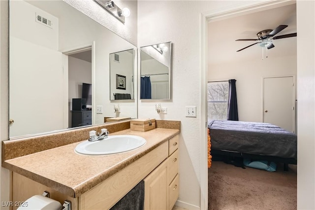 full bath featuring ensuite bathroom, ceiling fan, vanity, and visible vents