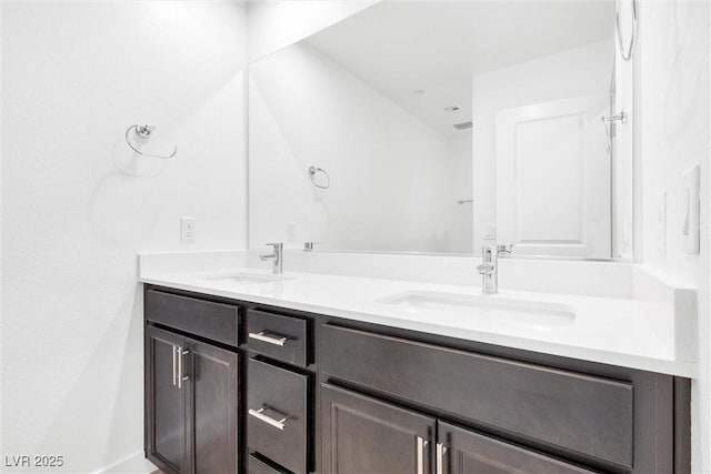 full bath with double vanity and a sink