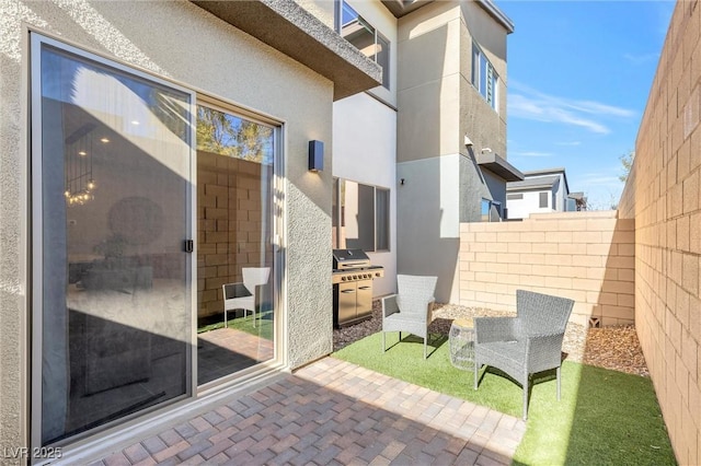 view of patio / terrace with fence and area for grilling