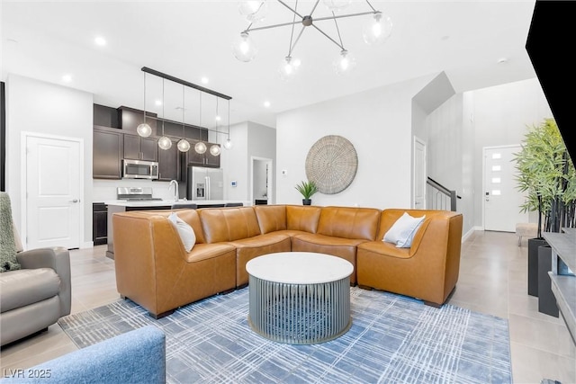living room featuring a chandelier, light tile patterned flooring, stairs, and recessed lighting