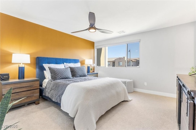 bedroom with baseboards, visible vents, ceiling fan, and light colored carpet