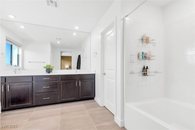 bathroom featuring double vanity, tile patterned flooring, visible vents, and a sink