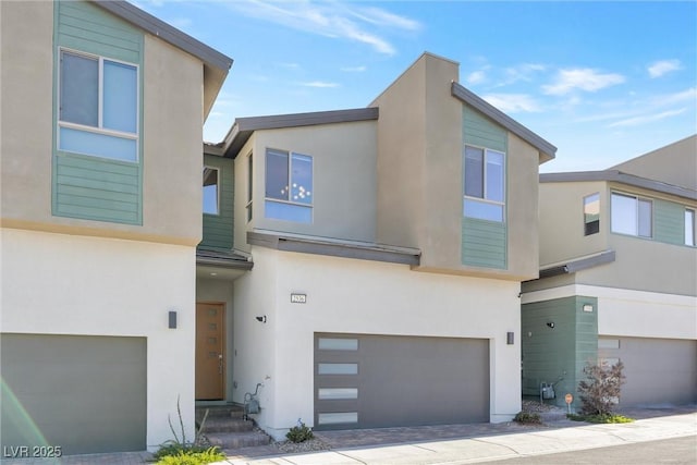 contemporary house with an attached garage and stucco siding