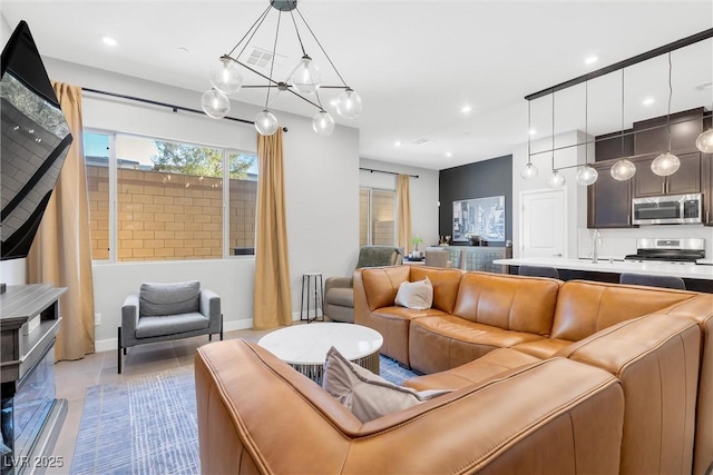 living room featuring recessed lighting and baseboards