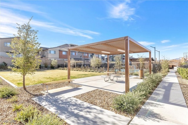 view of home's community featuring a yard, fence, a residential view, and a pergola