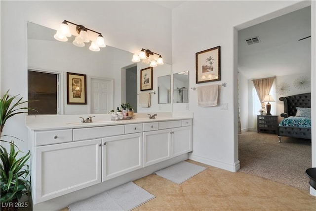 full bath with double vanity, baseboards, visible vents, ensuite bathroom, and a sink