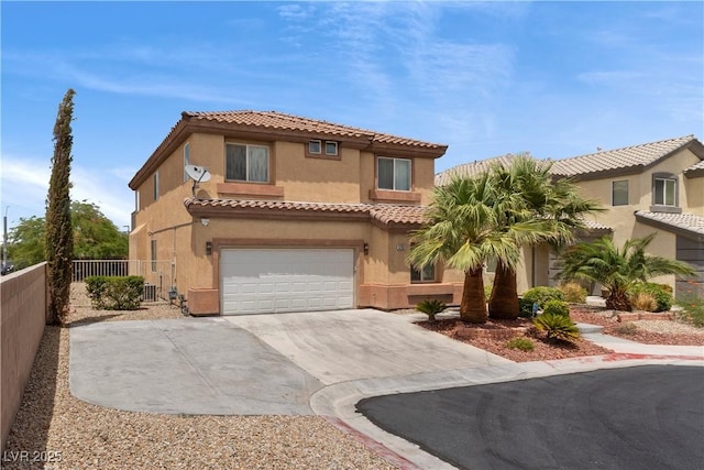 mediterranean / spanish-style home featuring an attached garage, fence, driveway, a tiled roof, and stucco siding