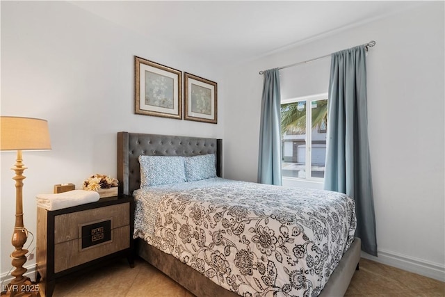 bedroom with baseboards and light tile patterned floors