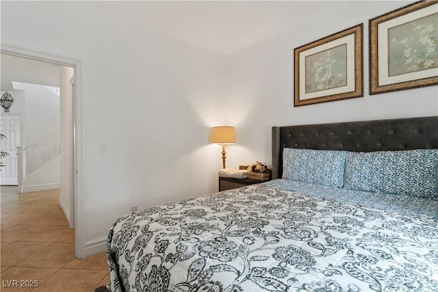 bedroom featuring baseboards and light tile patterned flooring